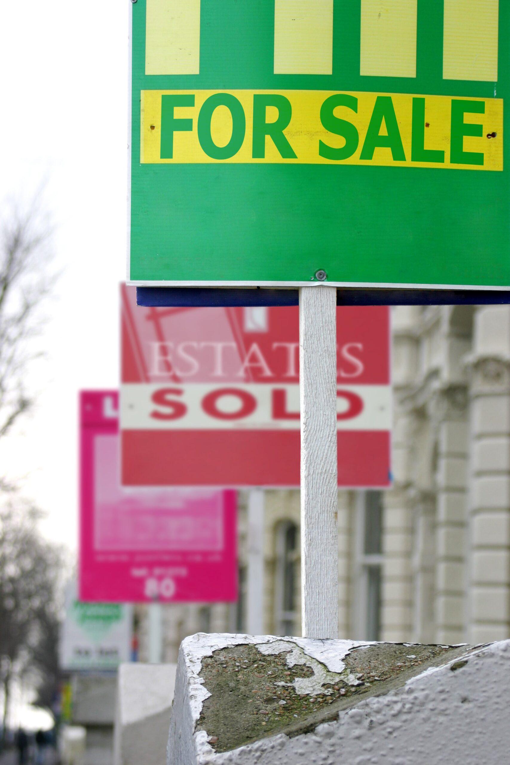 First-Time Buyers. For Sale boards in a row of houses showing that our mortgage advisors will offer you mortgage advice.