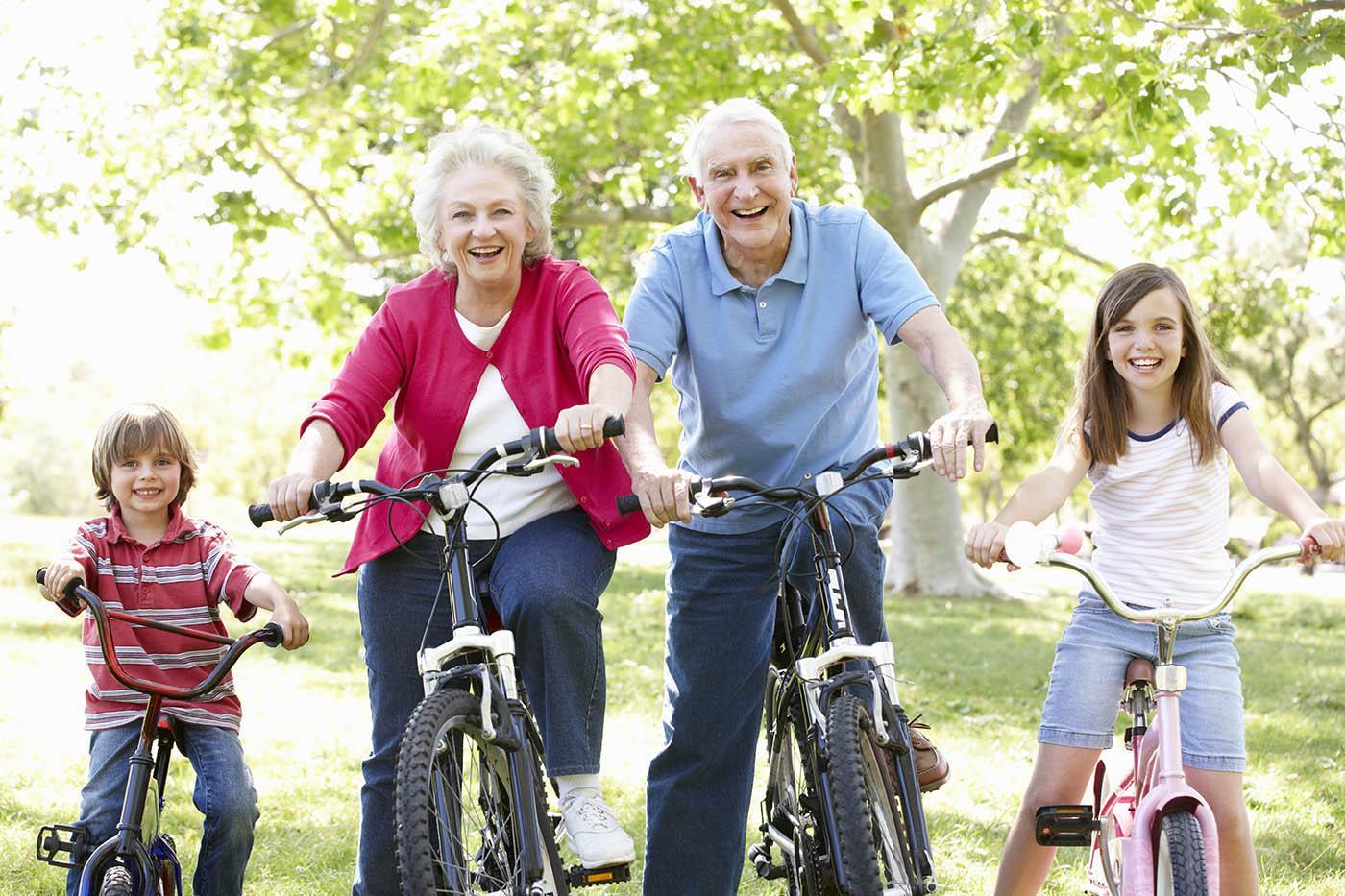 Retired couple on bikes with grand children showing what can be done with an equity release mortgage.