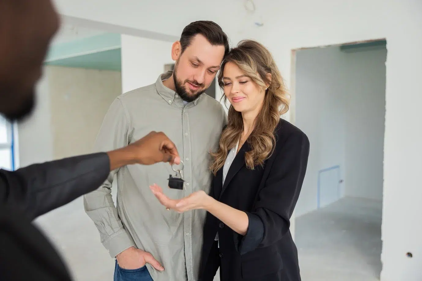 Landlord handing over property keys to tenant during rental agreement signing